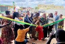 • Mrs Ophelia Mensah Hayford (with mic) and other dignatiries jointly cutting the ribbon to officially inaugurate the centre