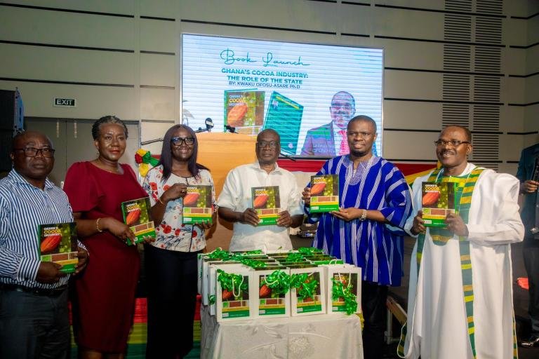 • Mr Yussif (second from right), Dr Ofosu-Asare (right), Dr Sarpong (third from right) and other dignitaries displaying copies of the book during the launch