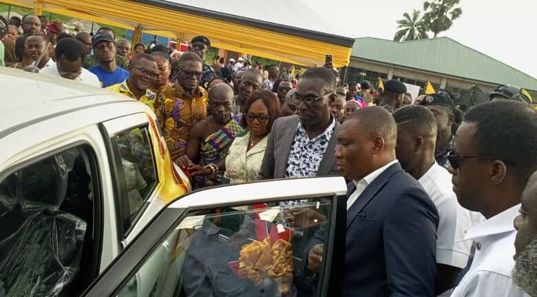 • Mr Duker (right) presenting the saloon car to Mr Archer