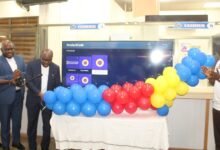 • Mr David Boadi Asamoah (third from left) cutting a tape to launch the ECG Infomercial system platform. Applauding are some senior staff of ECG Photo: Ebo Gorman