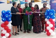 • Notse Nii Nortey Owuo IV (middle) assisted by Virginia Palmer (left) and Mrs Mamle Andrews to cut the tape to open the facility