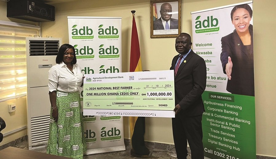 • Mr Addo recieving the dummy cheque from Mrs Ofori-Atta