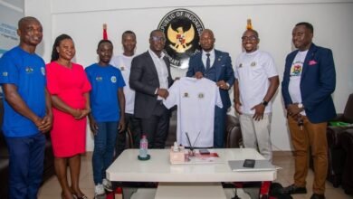 Mr Annan (third from right) presents a branded T-shirt to Mr Rois while other officials of the federation and embassy look on