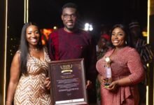 • Mr Clottey and his team displaying the award