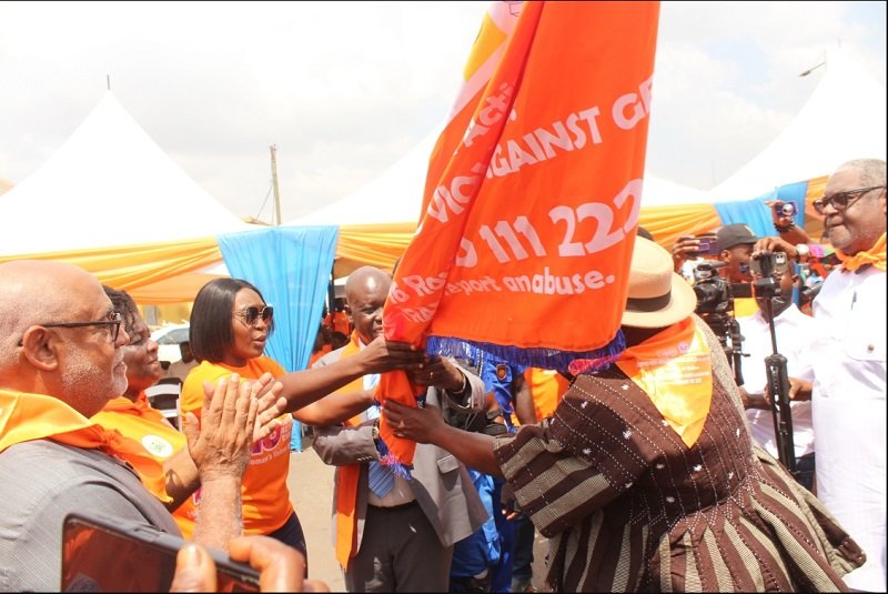 • Ms Dakoa Newman (third from left) handing over a flag to Mr Godfred Abugri (in smock), General Secretary, GPRTU, to symbolise end of gender-based violence Photo: Ebo Gorman