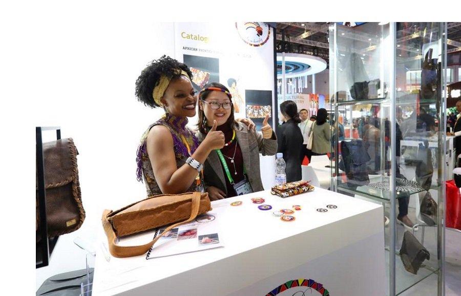 People pose for photos at the booth of South Africa at the 6th China International Import Expo (CIIE) in east China's Shanghai, Nov. 6, 2023. (Xinhua/Fang Zhe)