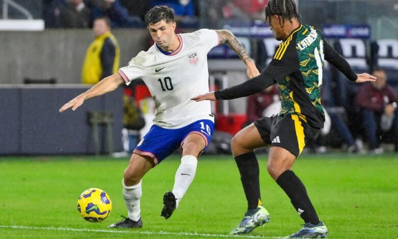 • United States forward Christian Pulisic (10) controls the ball away from Jamaica midfielder Joel Latibeaudiere