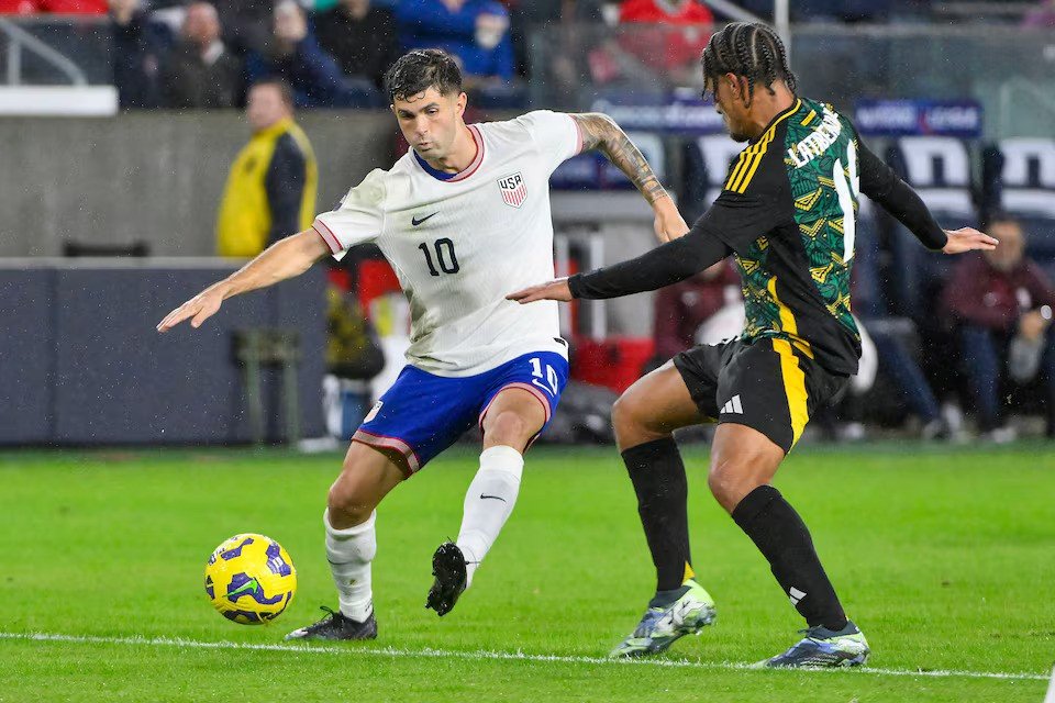 • United States forward Christian Pulisic (10) controls the ball away from Jamaica midfielder Joel Latibeaudiere