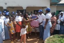 • Rev Sekum( right) presenting the items to Mrs Asiedu