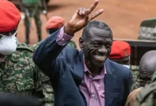 • Kizza Besigye, who has been held incommunicado for days, waving to his supporters on arrival at the military court