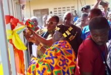 • Nana Adu Asante (right), Boryaa Chief assisting Mrs. Ursula Owusu Ekuful, to open the Rural Telephone and Digital inclusion Projects