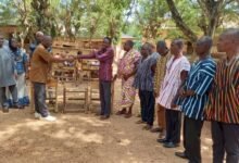 • Mr John Adza (left) presenting furniture to Mr Forster Udzu