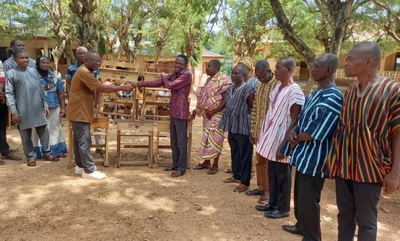 • Mr John Adza (left) presenting furniture to Mr Forster Udzu