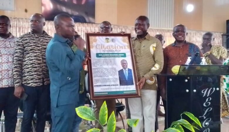 • Mr Joseph Boahen Aidoo (right) receiving his award from the leadership of the farmers group for his contributions to the sector