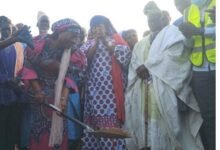 Hajia Fatahiya Abdul Aziz being assisted by the chiefs to cut the sod for work to commence