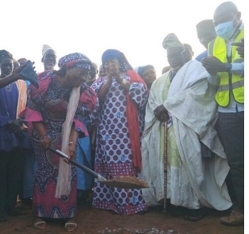 Hajia Fatahiya Abdul Aziz being assisted by the chiefs to cut the sod for work to commence