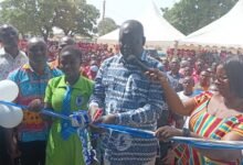 Dr Hafiz Bin Salih (middle) being assisted by Ms Mercy Babachuweh, Headmistress, NAVASCO, to cut the tape to open dormitory facility