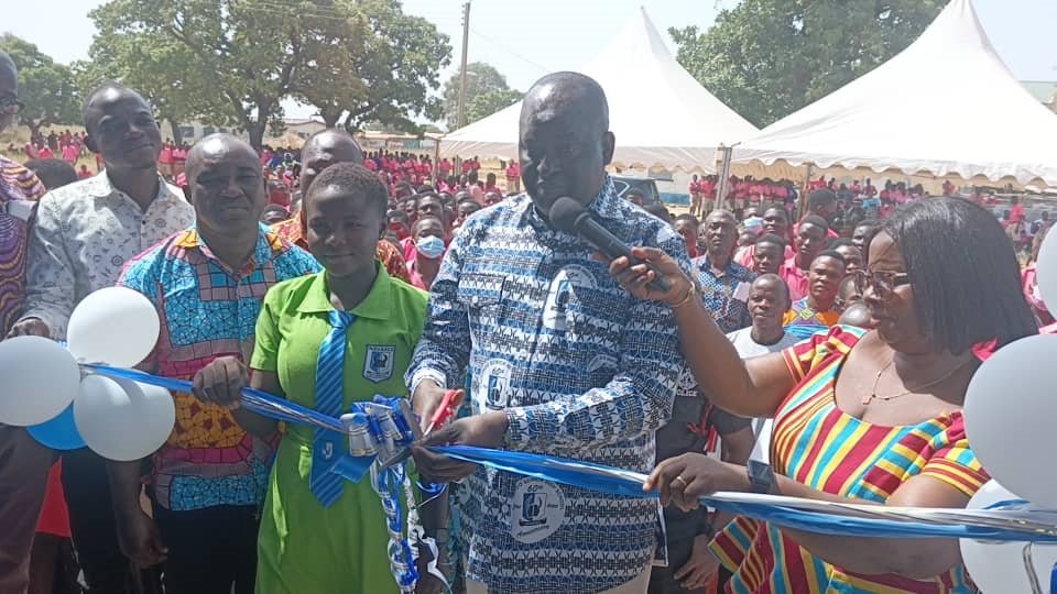 Dr Hafiz Bin Salih (middle) being assisted by Ms Mercy Babachuweh, Headmistress, NAVASCO, to cut the tape to open dormitory facility