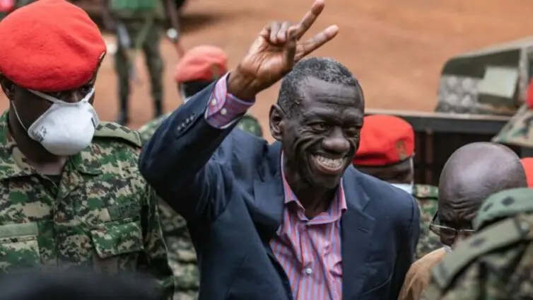 • Kizza Besigye, who has been held incommunicado for days, waving to his supporters on arrival at the military court