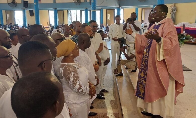 • Reverend Father Stephen Oscar Amo (right) offering prayers o,nto the NDC members