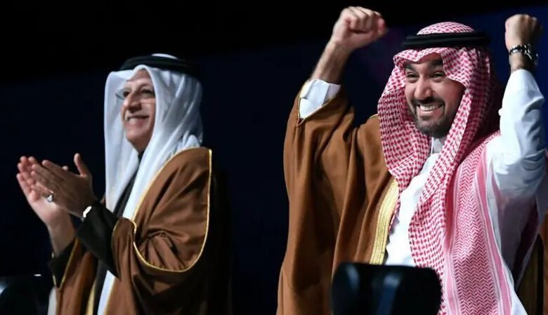 • Asian Football Confederation President Sheikh Salman bin Ibrahim al-Khalifa and Saudi Arabia's Minister of Sports and Youth, Abdulaziz bin Turki Al Faisal, celebrate the announcement