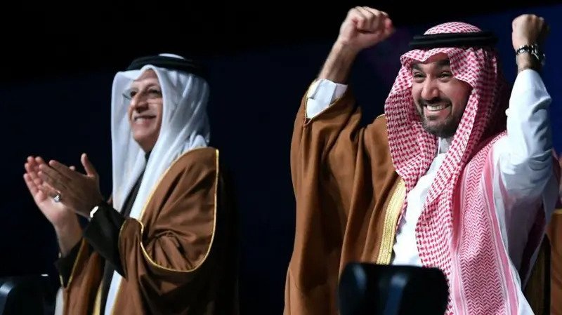 • Asian Football Confederation President Sheikh Salman bin Ibrahim al-Khalifa and Saudi Arabia's Minister of Sports and Youth, Abdulaziz bin Turki Al Faisal, celebrate the announcement