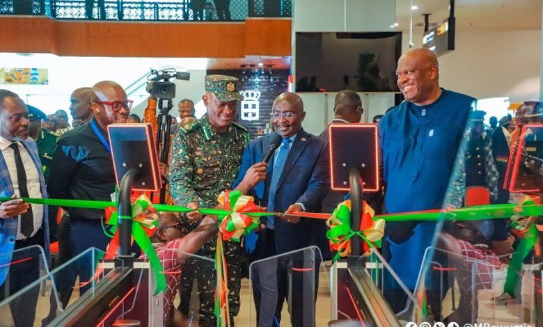 • Vice President Bawumia (middle) cutting the tape to inaugurate the e-Gate system