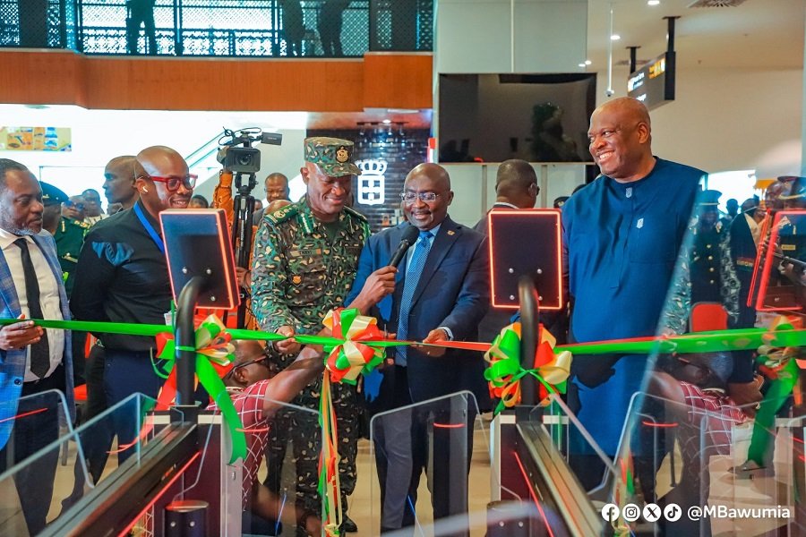 • Vice President Bawumia (middle) cutting the tape to inaugurate the e-Gate system