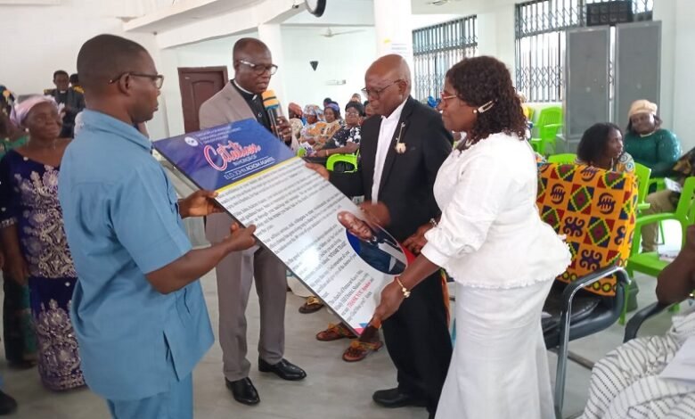 • Elder Ackom-Asante (second from right) and wife, Christiana receiving the citation from the church