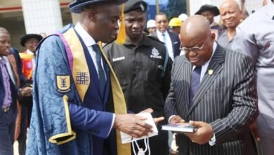 President Akufo-Addo (right) being presented with a copy of a book from Prof. Abednego F. O Amartey, Vice-chancellor, UPSA.