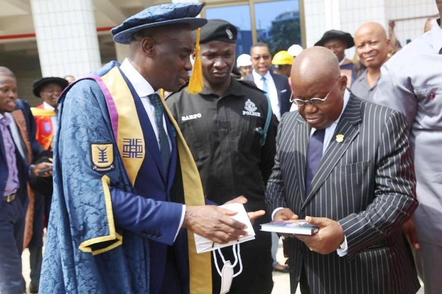 President Akufo-Addo (right) being presented with a copy of a book from Prof. Abednego F. O Amartey, Vice-chancellor, UPSA.