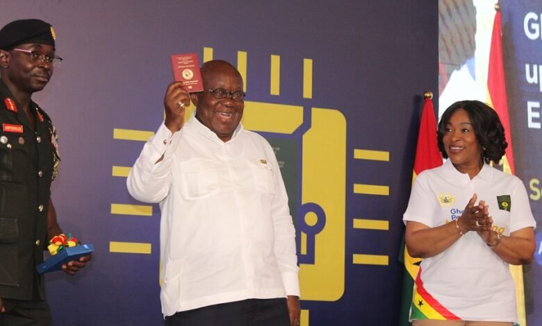 President Akufo-Addo showing the Chip Embedded Passport after the launch. Applauding is Ms Shirley Ayorkor Botchhwey. Photo. Ebo Gorman