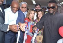 Mr Ramesh Sadhwani (second from left) with Mr Olympia (left) and other dignitaries after cutting the tape to open the Melcom shop at Accra Mall Photo:Victor A. Buxton