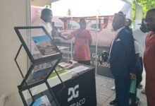 • Mr Osei-Owusu (in suit) interacting with one of the exhibitors during a tour of the exhibition stands