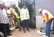 • Mrs Lydia Seyram Alhassan (right) turning on a tap at a house in Kwashieman Photo: Seth Osabukle