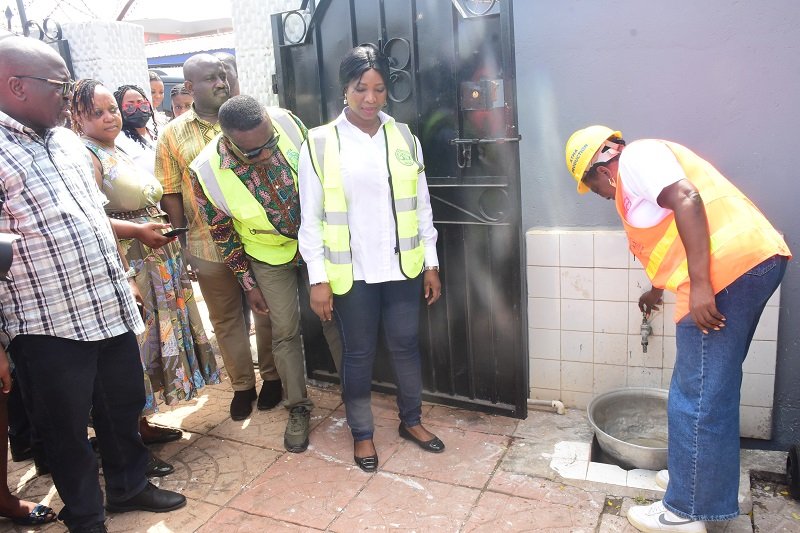• Mrs Lydia Seyram Alhassan (right) turning on a tap at a house in Kwashieman Photo: Seth Osabukle
