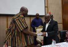 President Akufo-Addo (right) presenting documents to President- elect John Dramani Mahama