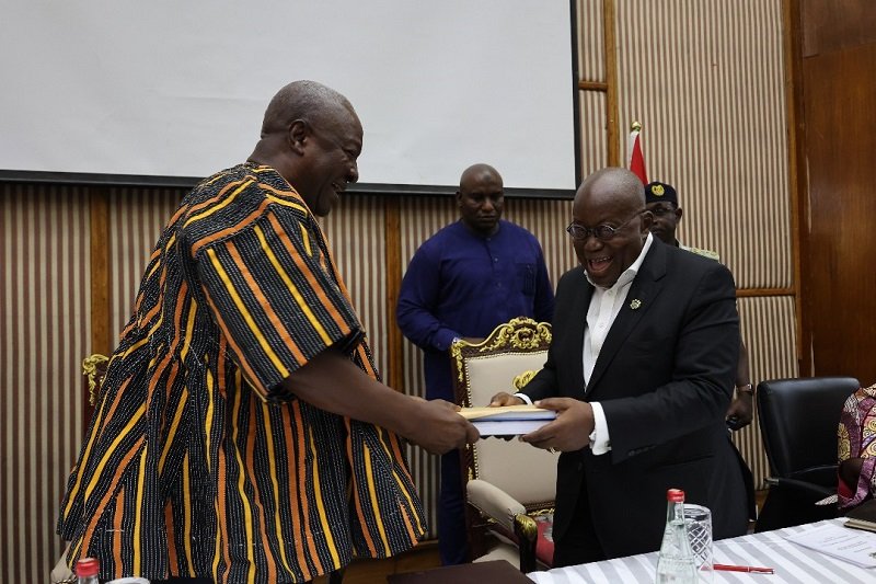 President Akufo-Addo (right) presenting documents to President- elect John Dramani Mahama