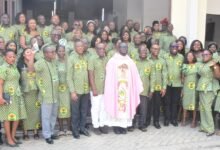 • Reverend Father Gerald Owusu-Amankwatia (middle) with management and staff of DVLA after the church service Photo: Seth Osabukle