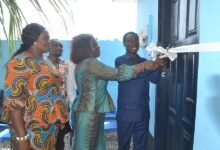 • Mr Nkrumah (right) being asssited by Ms Kotomah (middle) to cut the tape to hand over the WASH facility to Presec SHS . With them include Ms Tetteh Photo Victor A. Buxton