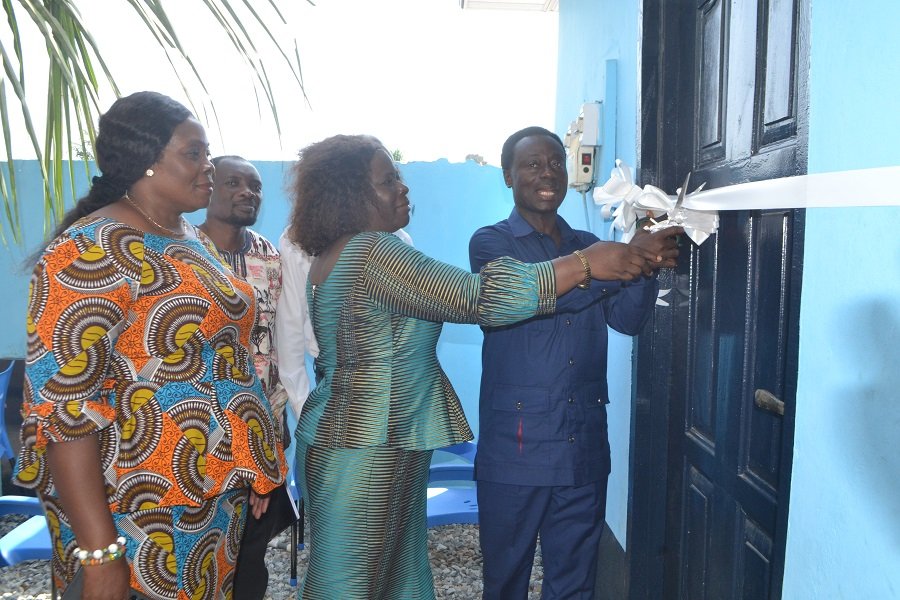 • Mr Nkrumah (right) being asssited by Ms Kotomah (middle) to cut the tape to hand over the WASH facility to Presec SHS . With them include Ms Tetteh Photo Victor A. Buxton