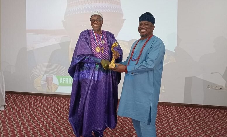 • Alhaji Haroon (left) receiving his award from The Publisher and Editor-in-Chief of the Elation Magazine