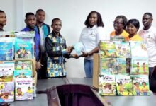 • Mr Naabah receiving the books from Ms Amponsah