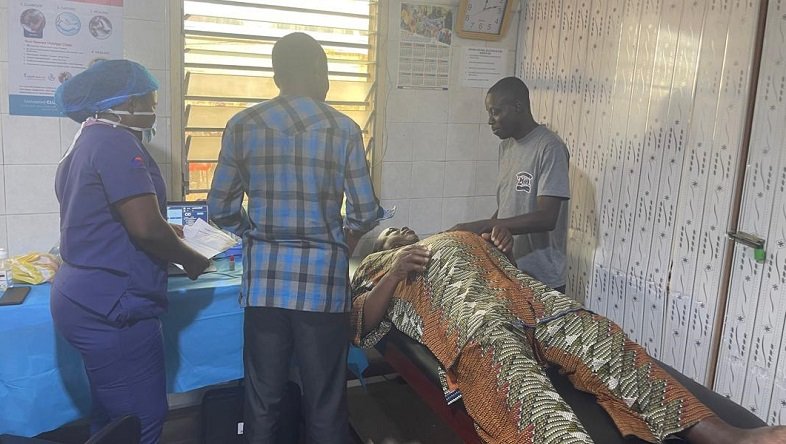• Health workers examining a patient