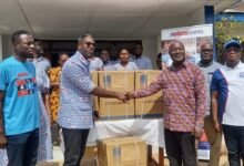 • Mr Andrew Achampong-Kyei presenting some of the items to Dr Richard Anthony