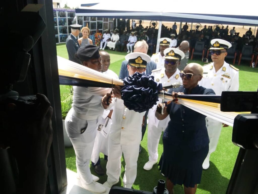 Ms Marietta Brew (right) supported by Commodore Bro Overgaard (middle) to cut the tape to open the facility