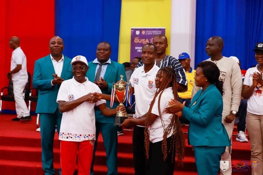 • Prof. Boampong, Vice Chancellor of UCC, handing over the GUSA trophy to the UCC team