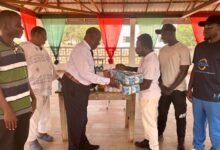 • Emmanuel Quartey (left) presenting the items to Father Caleb