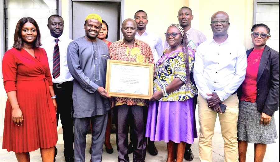 • Mrs Quaittoo (third from right) and Alhaji Abdul-Rahaman (second from left) holding the certificate. With them are other Management Staff of NTC and GSA staff Photo: Stephanie Birikorang