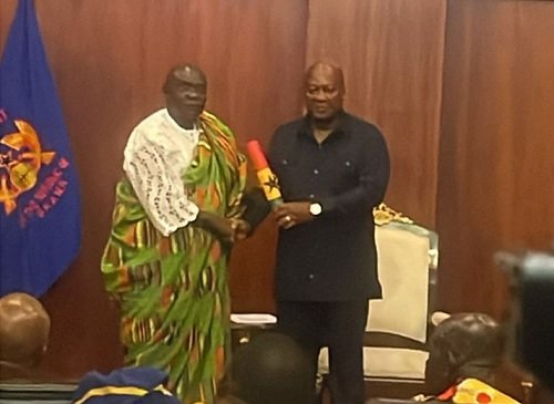 President Mahama (right) presenting the scroll of office to Mr Edward Doe Adjaho, Chairman, Council of State